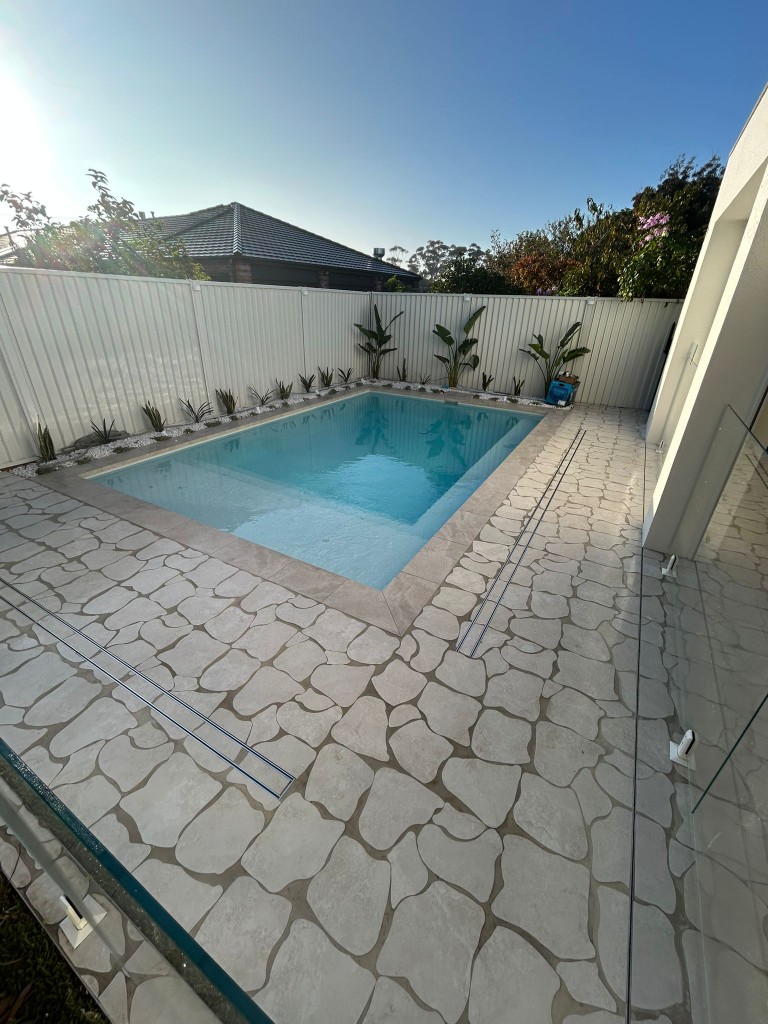 Crazy-paving stone pavers sealed around a backyard pool by Claraseal Melbourne