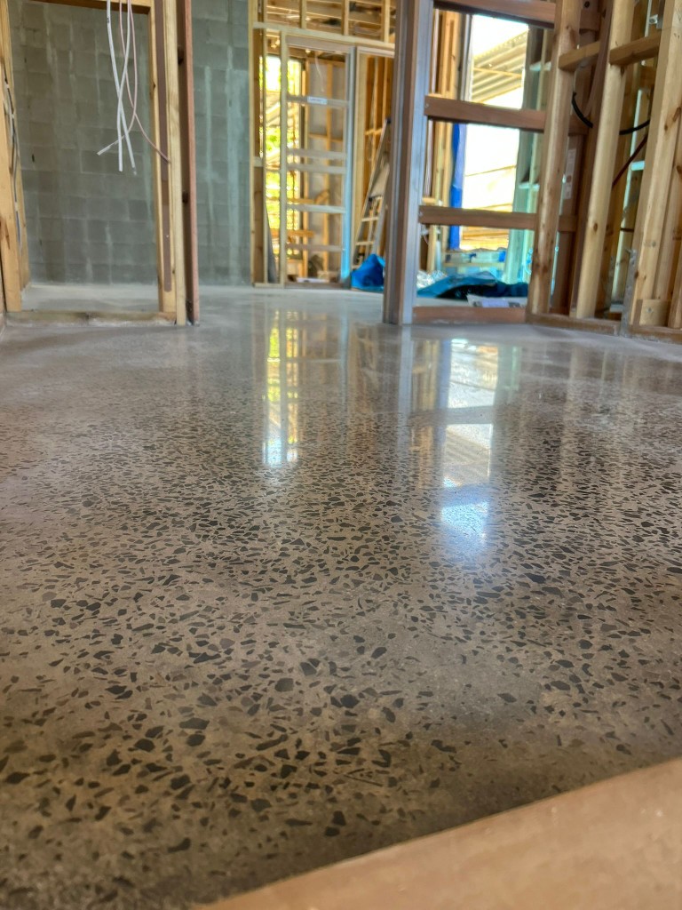 Polished concrete during residential build with timber framing