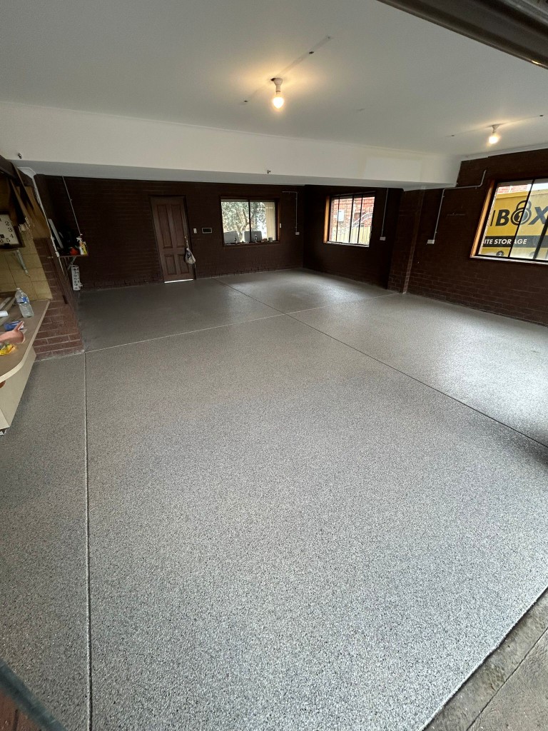 Grey epoxy flake floor in a Melbourne residential garage by Claraseal
