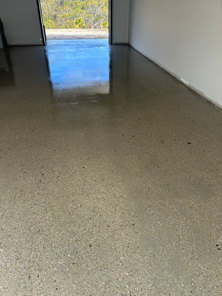 Polished concrete in industrial garage showing wet seal contrast