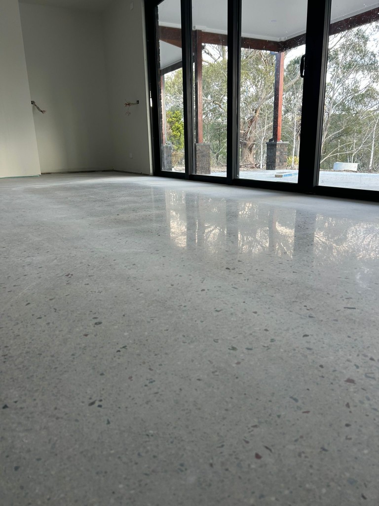 Subtle polished concrete in modern home overlooking bushland