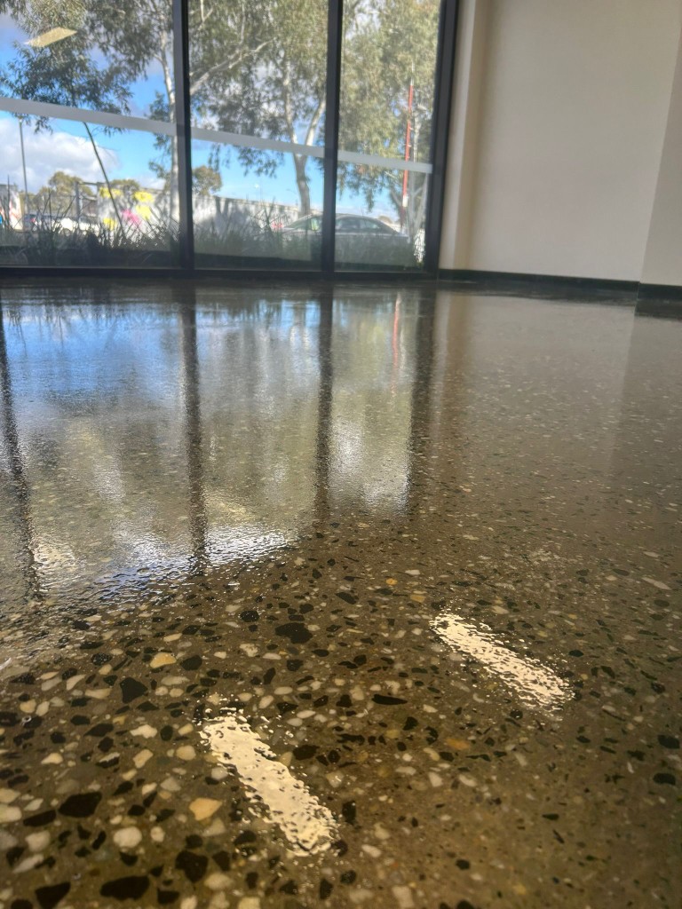 Polished concrete with golden tones in commercial showroom