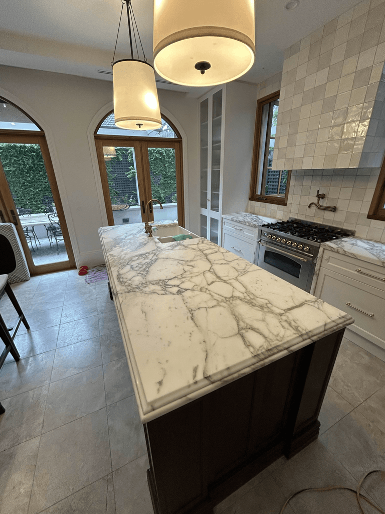 Calacatta marble waterfall benchtop with bold grey veining in classic Melbourne kitchen