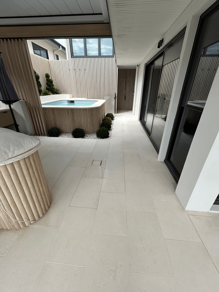 Honed limestone paving courtyard with timber-clad plunge pool at modern Melbourne home