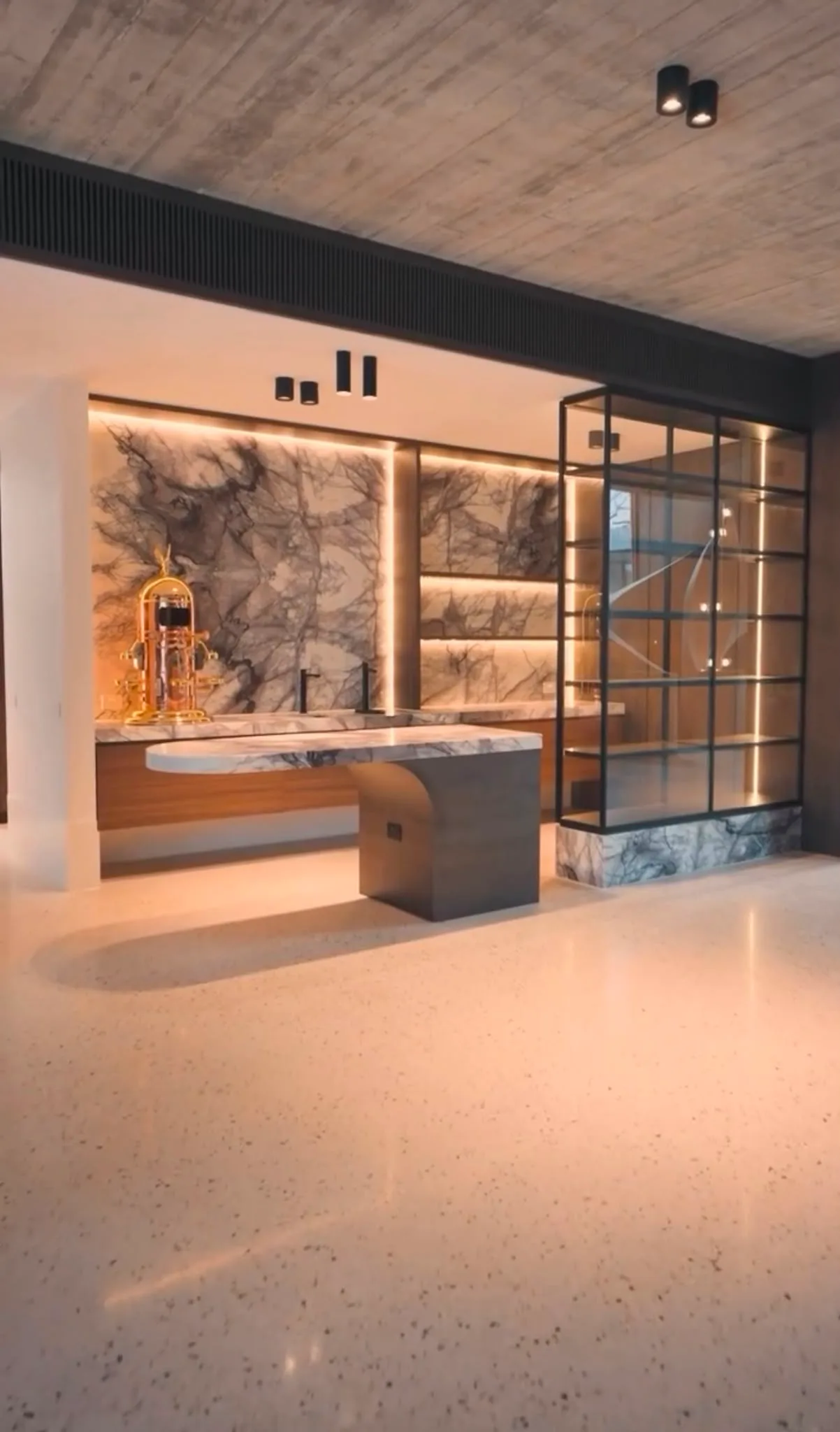 Polished floor in luxury showroom interior with backlit Italian marble wall and black steel partitions