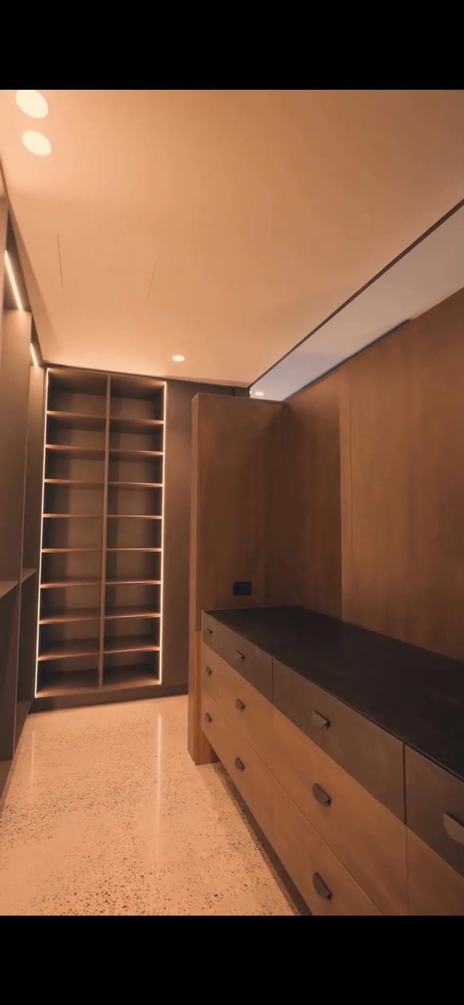 Cream speckle floor in luxury walk-in wardrobe with timber joinery and recessed downlights, Claraseal Melbourne